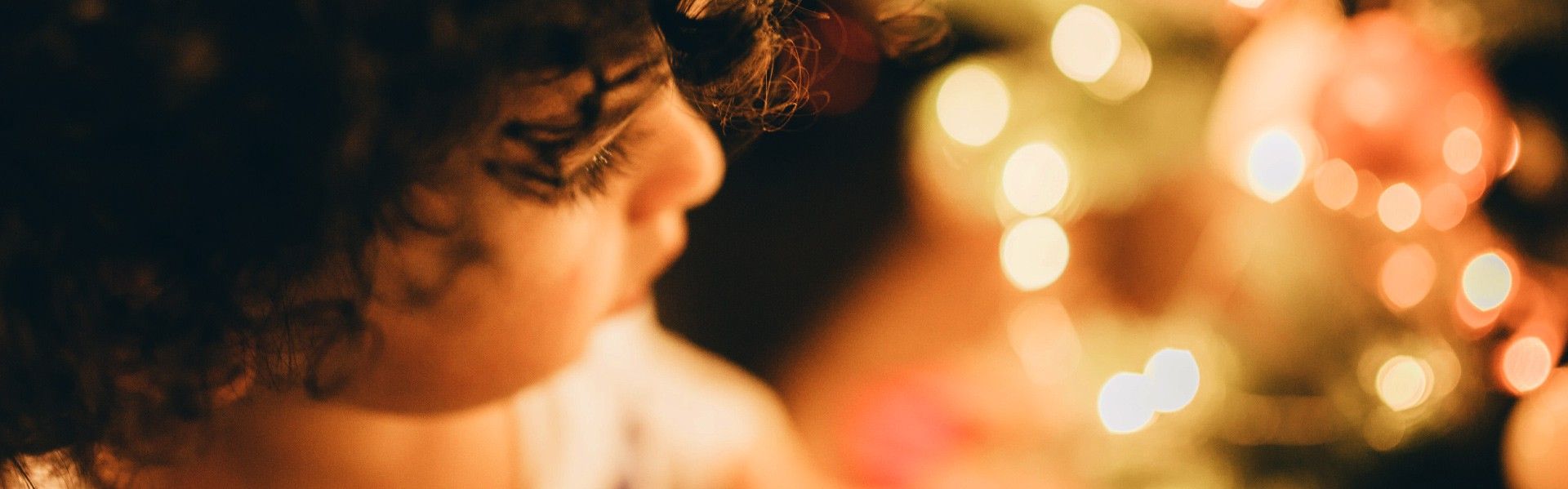 A young child and fairy lights