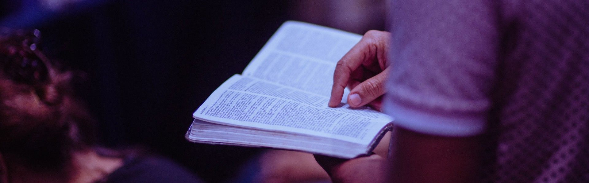 A person reading the bible and praying